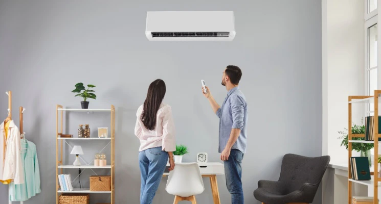 Two people standing in a room for Ac maintenance in Abu Dhabi