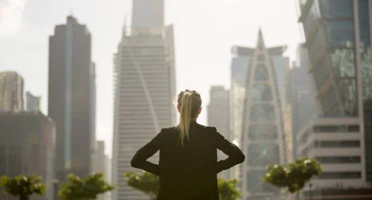 woman looking at high rise buildings